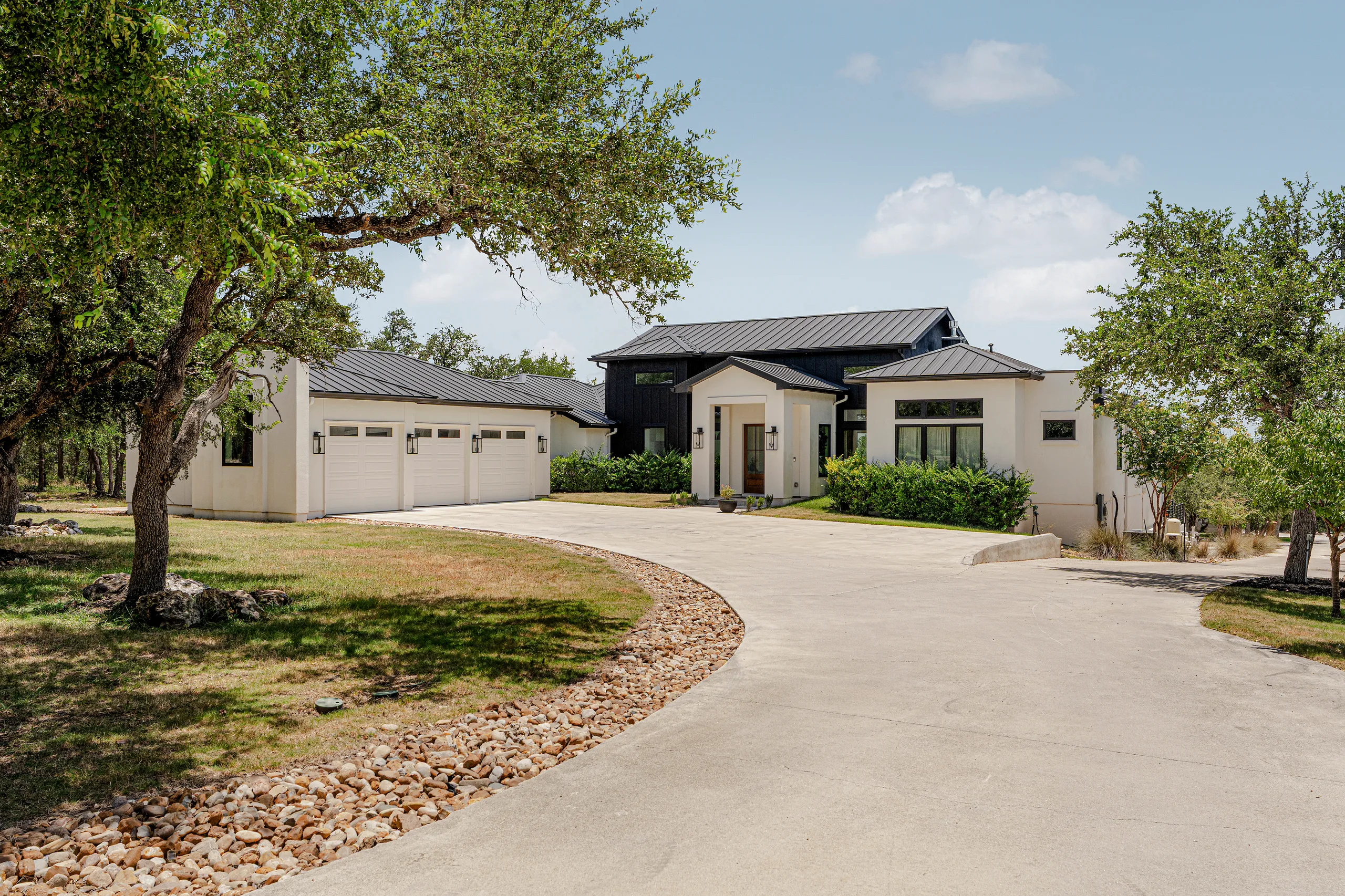A Hill Country home surrounded by mature oaks in Wimberley